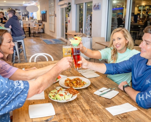 group dining at santiago's raising glasses in cheers